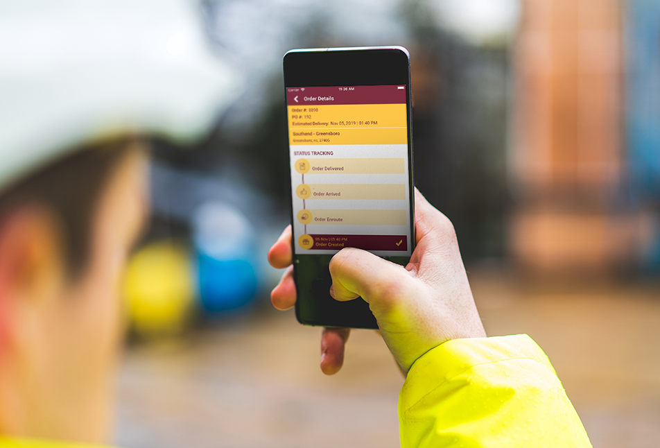 Mobile app on phone being held by worker